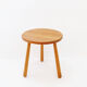 Vintage solid wood side table with rounded legs.