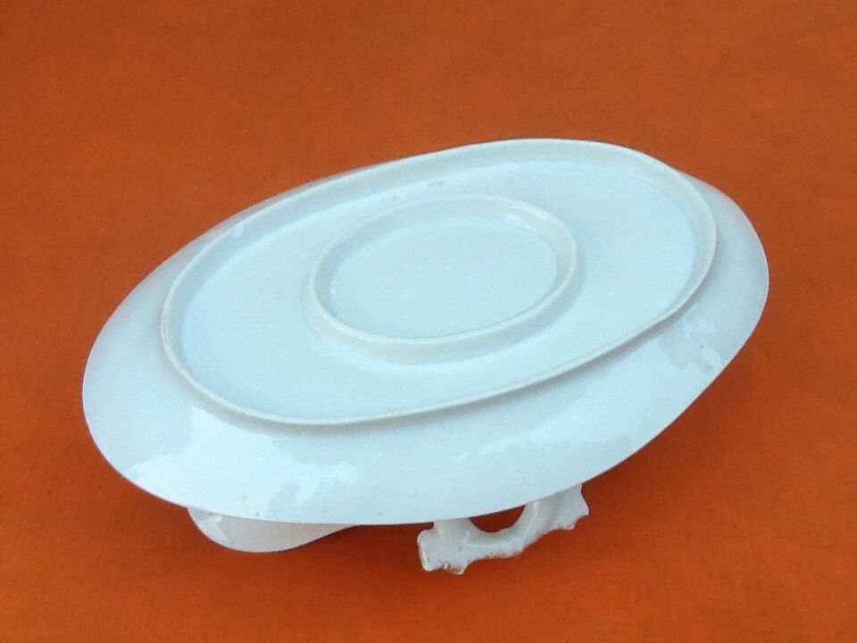 Sauce boat on dormant white porcelain, floral decoration