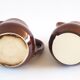 Duo of brown enamel pitchers