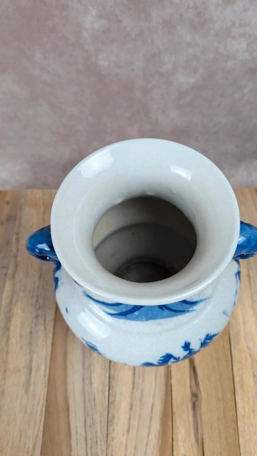 Blue and white Chinese vase with sculpted handles and landscape decoration.