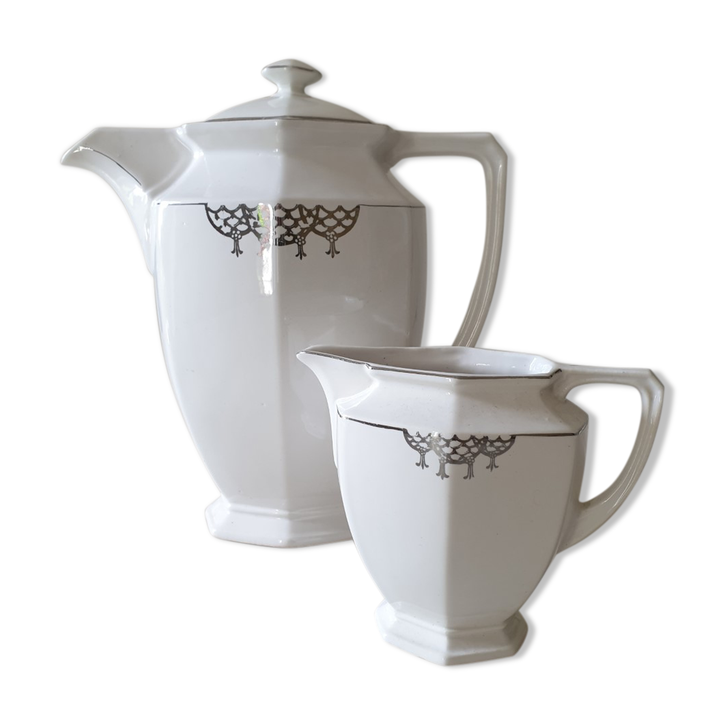 Old coffee maker and its milk pot