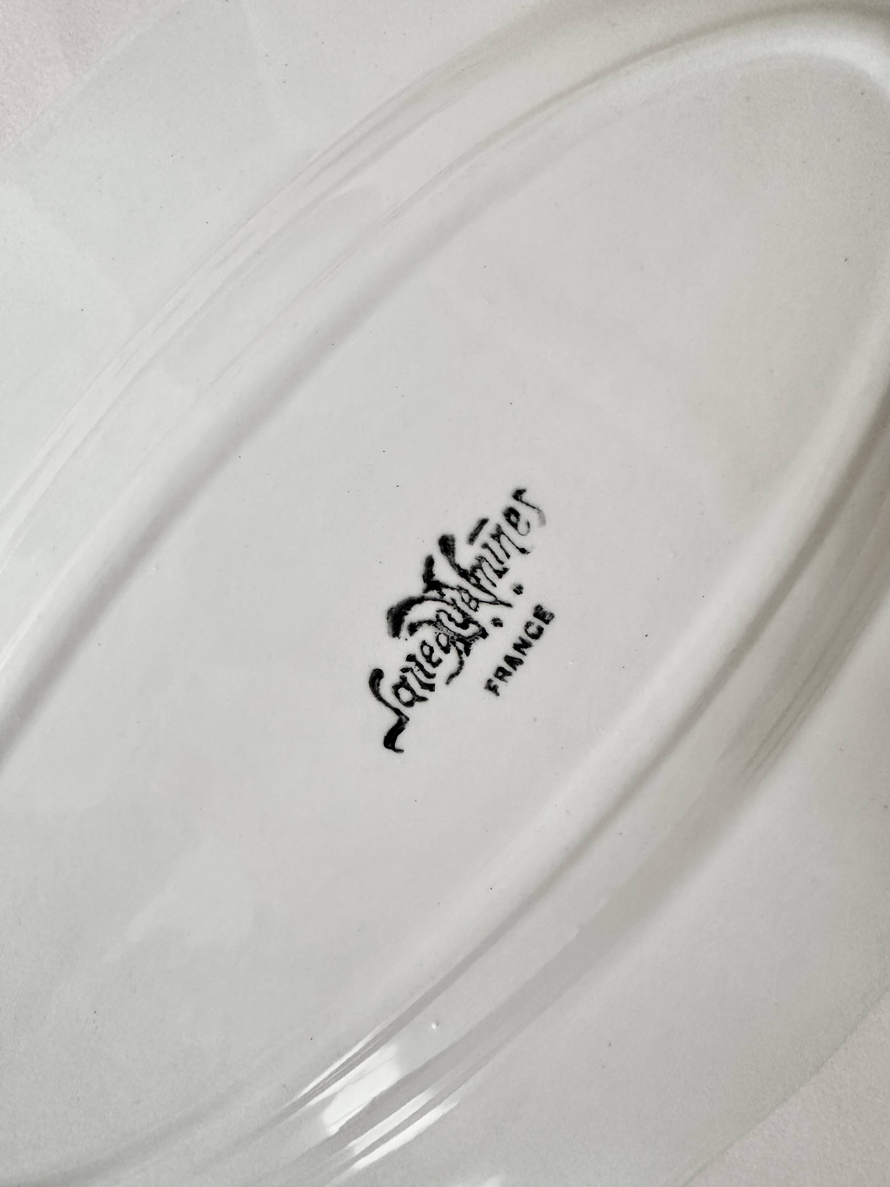 Shaped plates and dishes in Sarreguemines earthenware.
