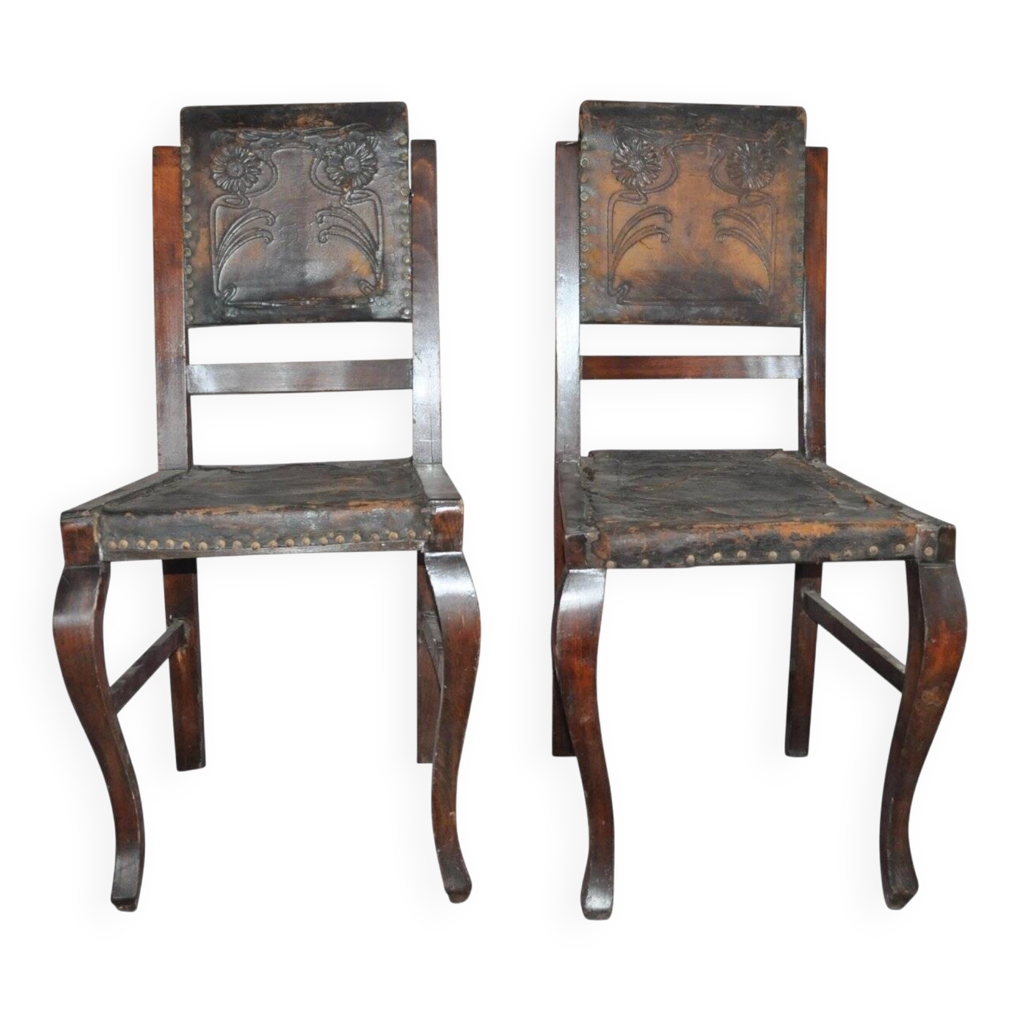 Pair of brown embossed leather chairs with brass studs and wooden frame, 1900s