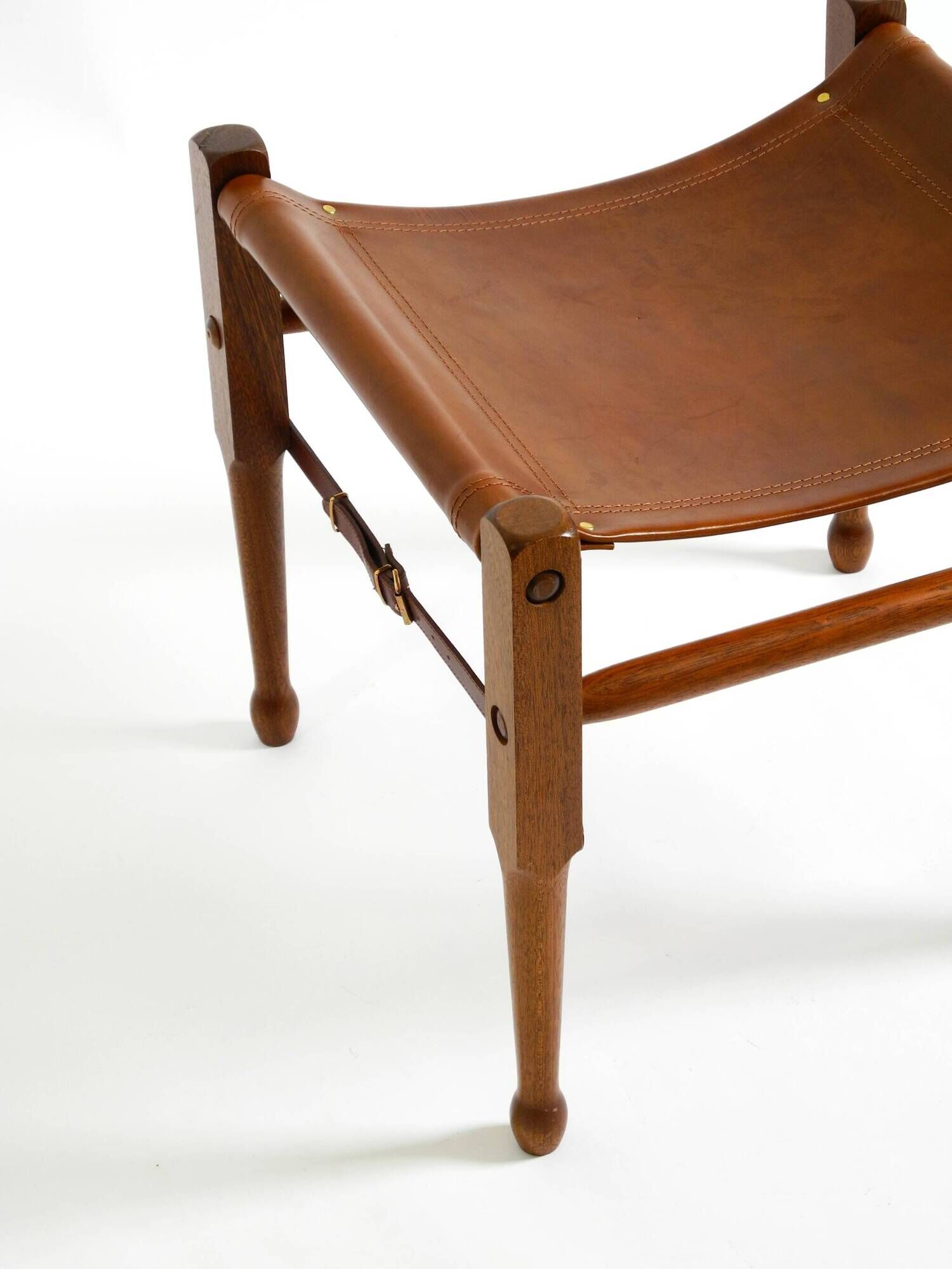 Rare 1990s safari stool with a teak frame and a seat made of brown saddle l