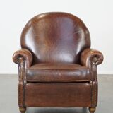 Sheep leather armchair on wheels