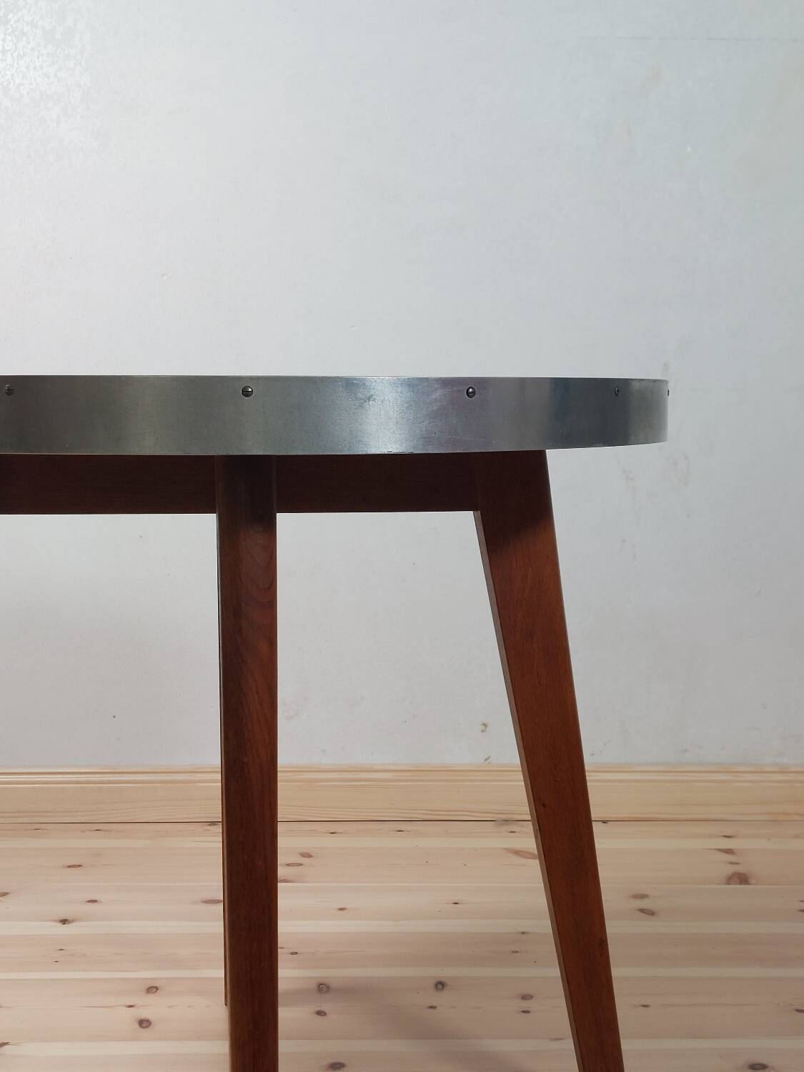 Vintage metal and teak side table from the 1950s.