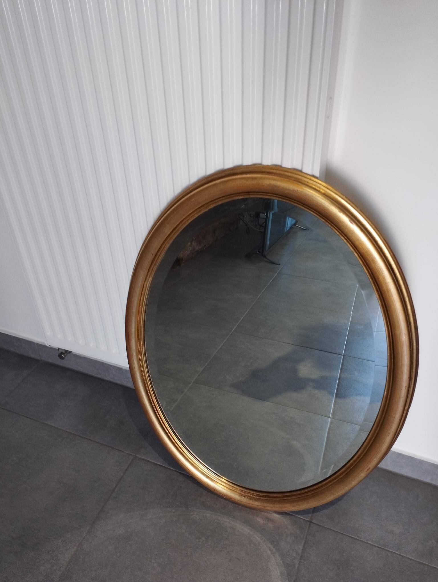 Grand et élégant miroir doré ovale avec sa glace biseauté