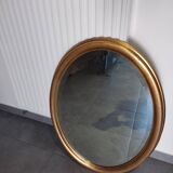Large and elegant oval gilded mirror with its beveled glass