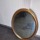 Grand et élégant miroir doré ovale avec sa glace biseauté