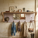 Coat rack or wall-mounted entrance wardrobe with scroll arms and antique hooks.