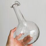 Twisted blown glass carafe with stopper, elegant design.