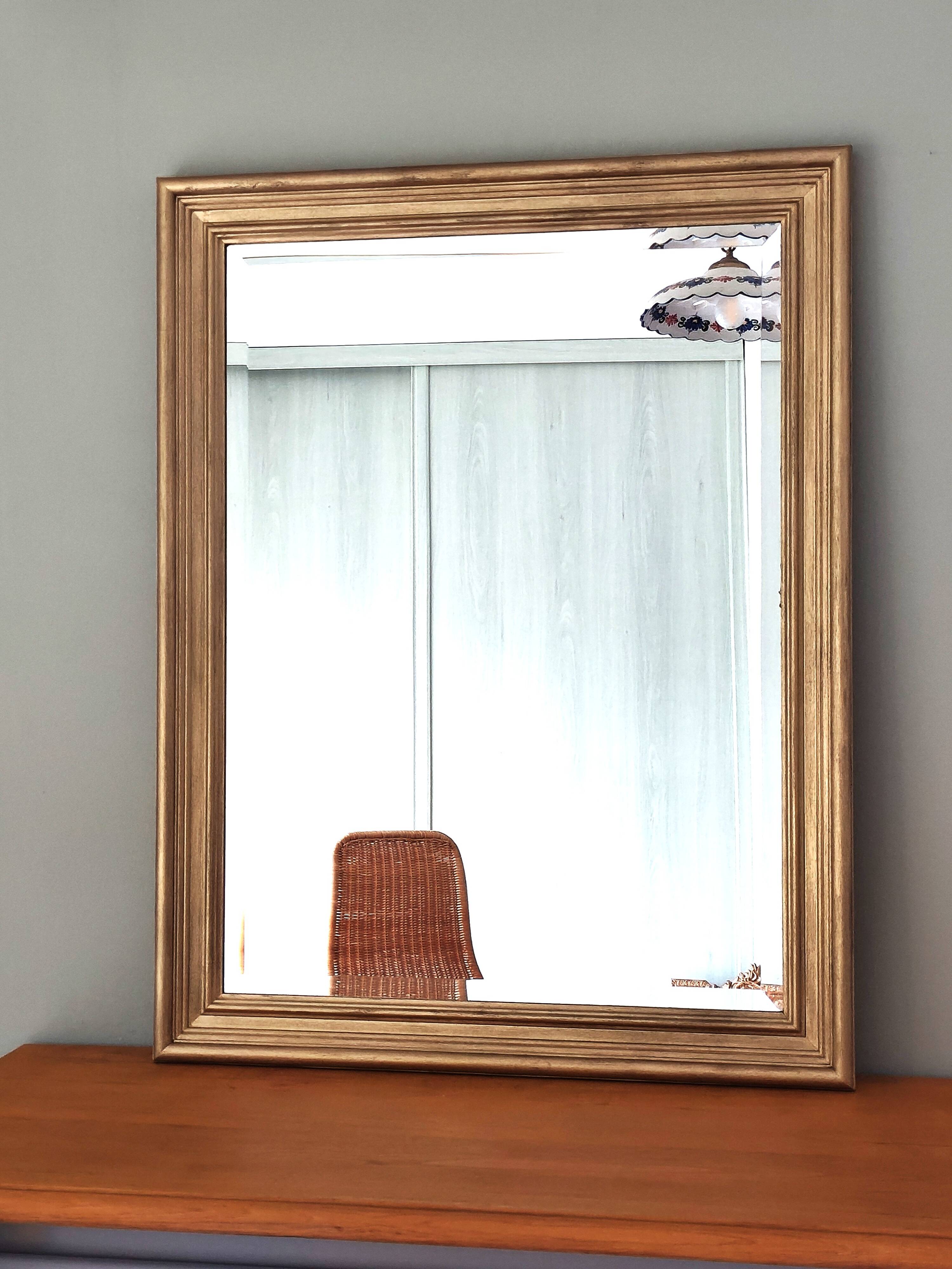 Large gold-framed mirror with bevelled glass.