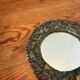 Round mirror in gilded enamelled ceramic with inlay