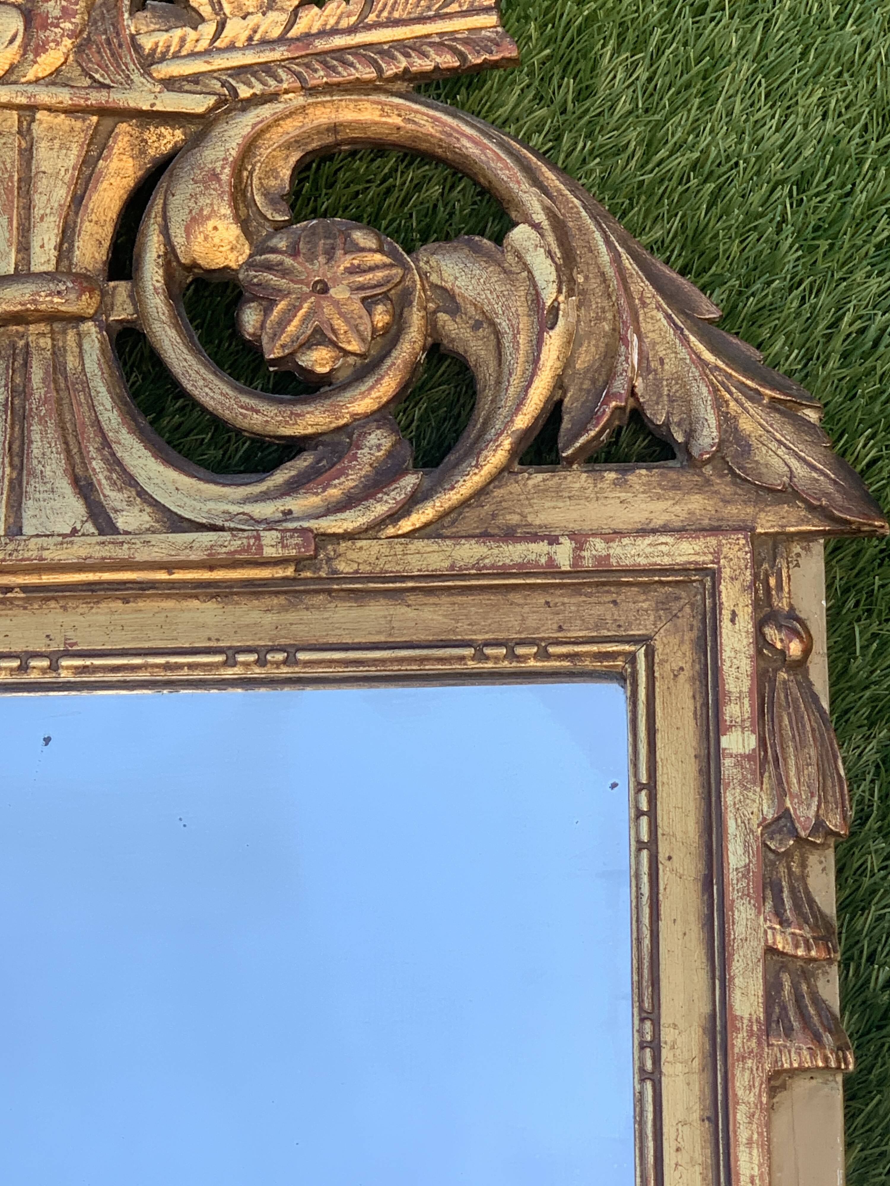 Antique mirror with gilded wood pediment, Louis XVI style