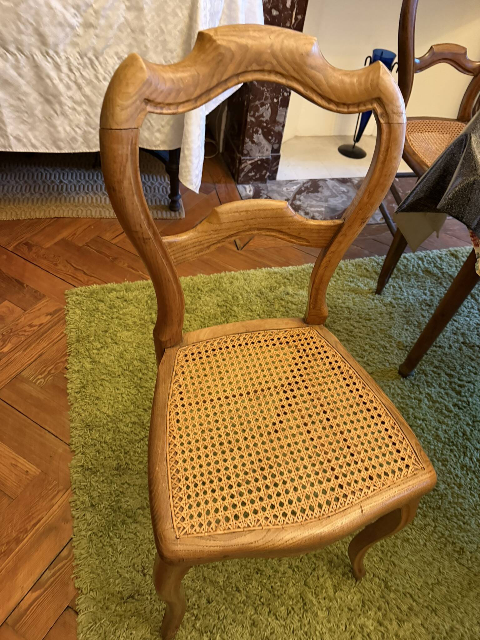 Light medallion chairs and carved fruit chairs.