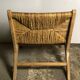 Fauteuil bas en bois brut avec assise et dossier paillé