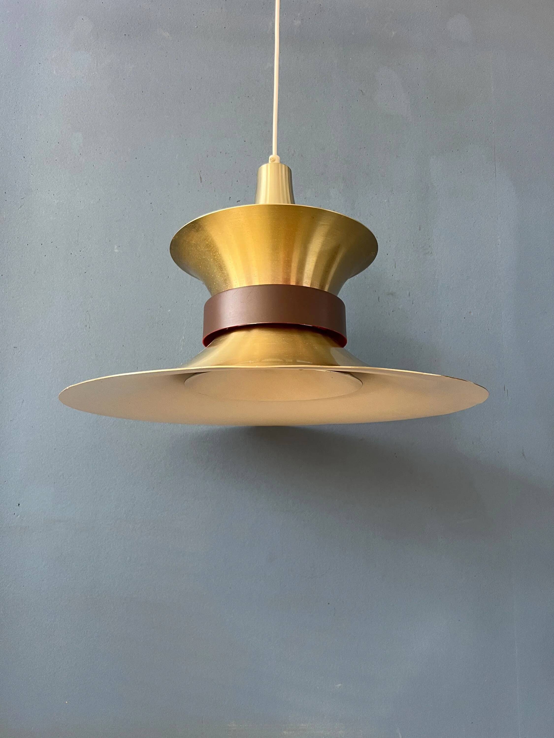Large UFO flying saucer pendant light with orange light.