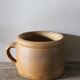 Round terracotta milk jug with handle
