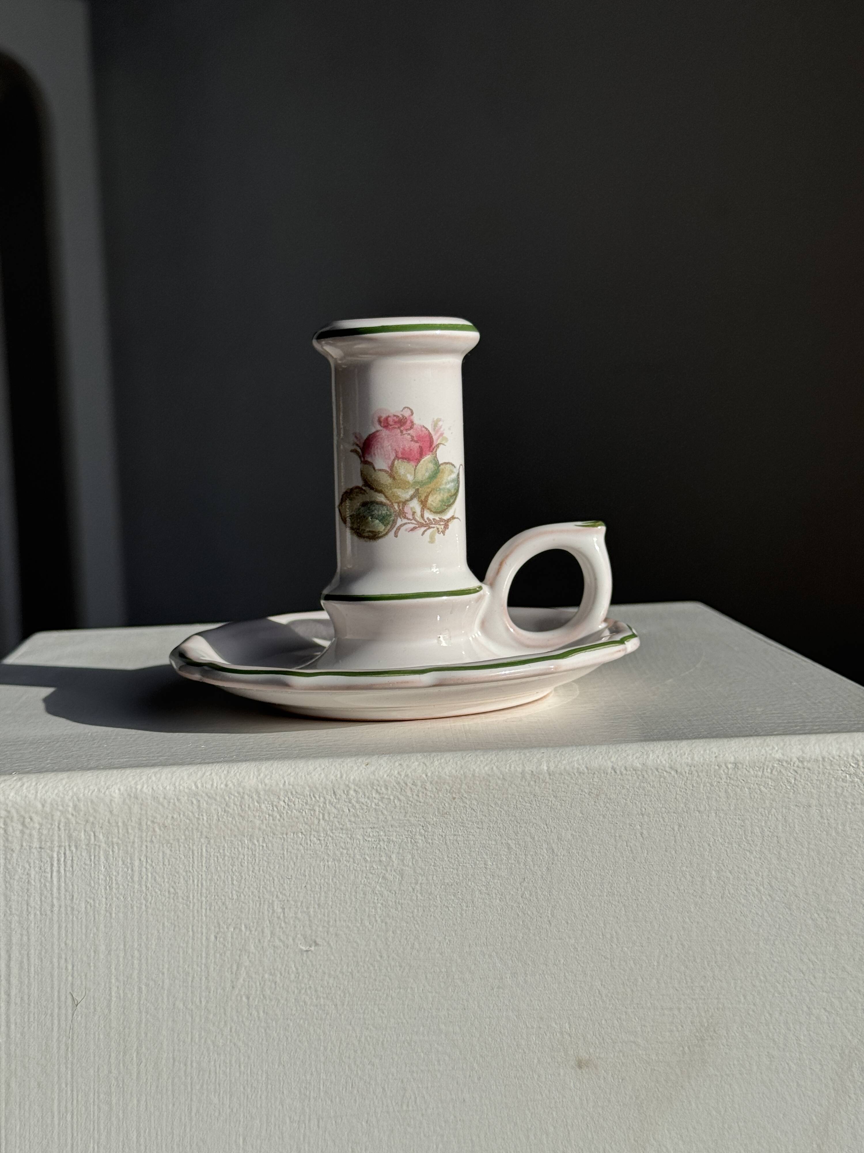 Small vintage hand-held candlestick in earthenware with green trim and floral decoration H10.5