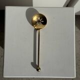 Small golden glass ice bucket with diamond point design and its scoop.