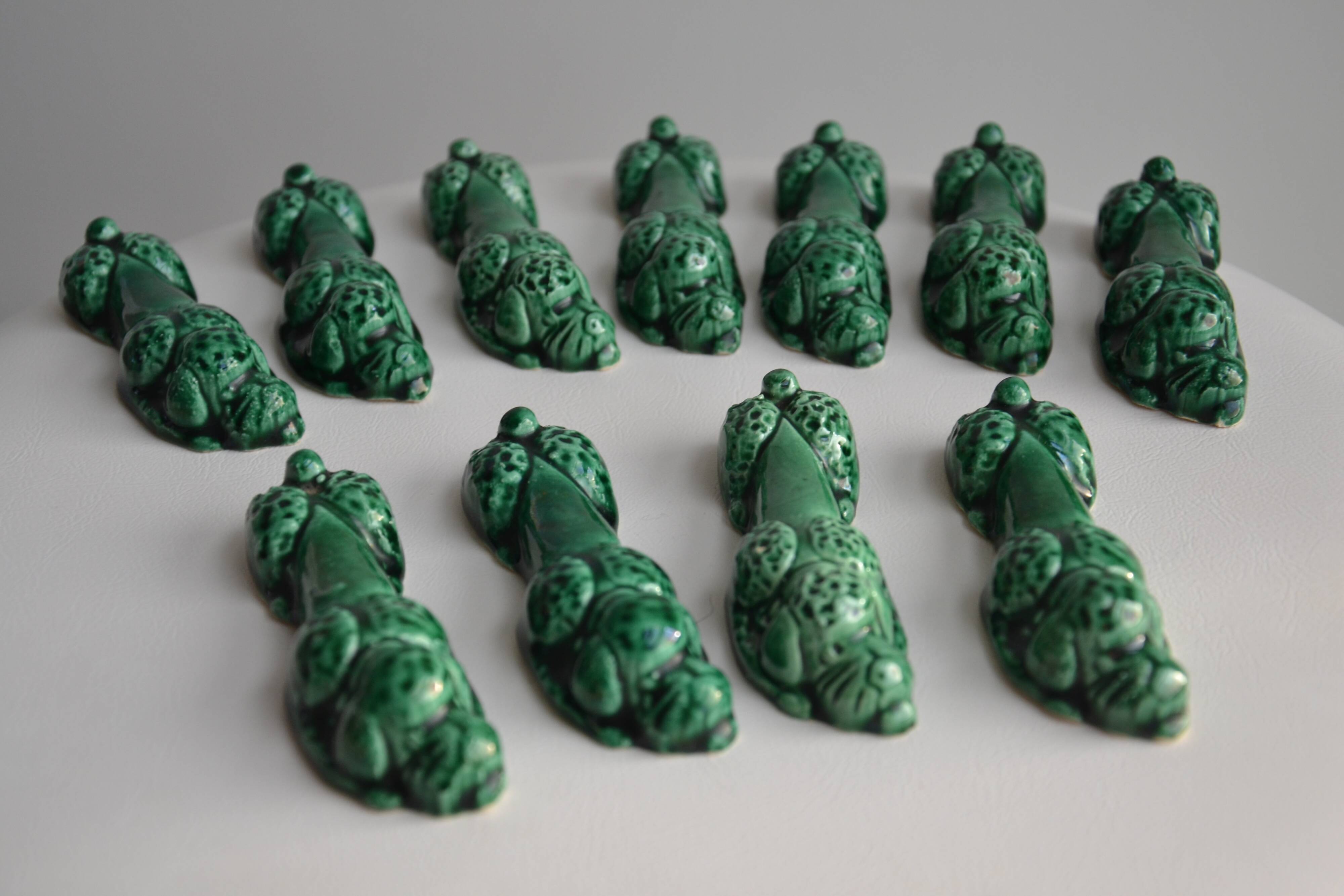 12 green earthenware knife rests