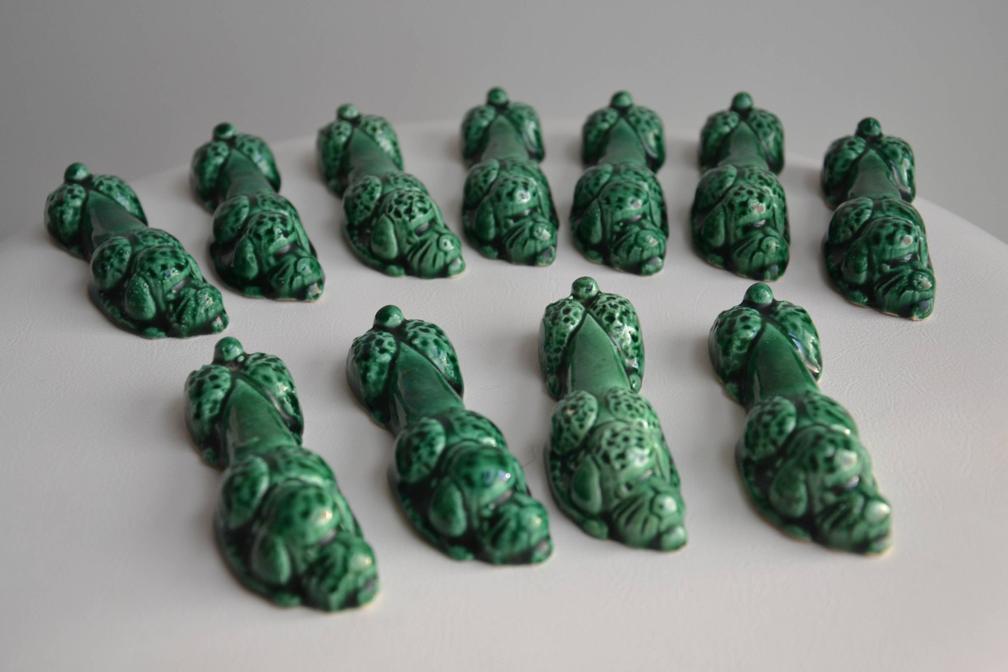 12 green earthenware knife rests