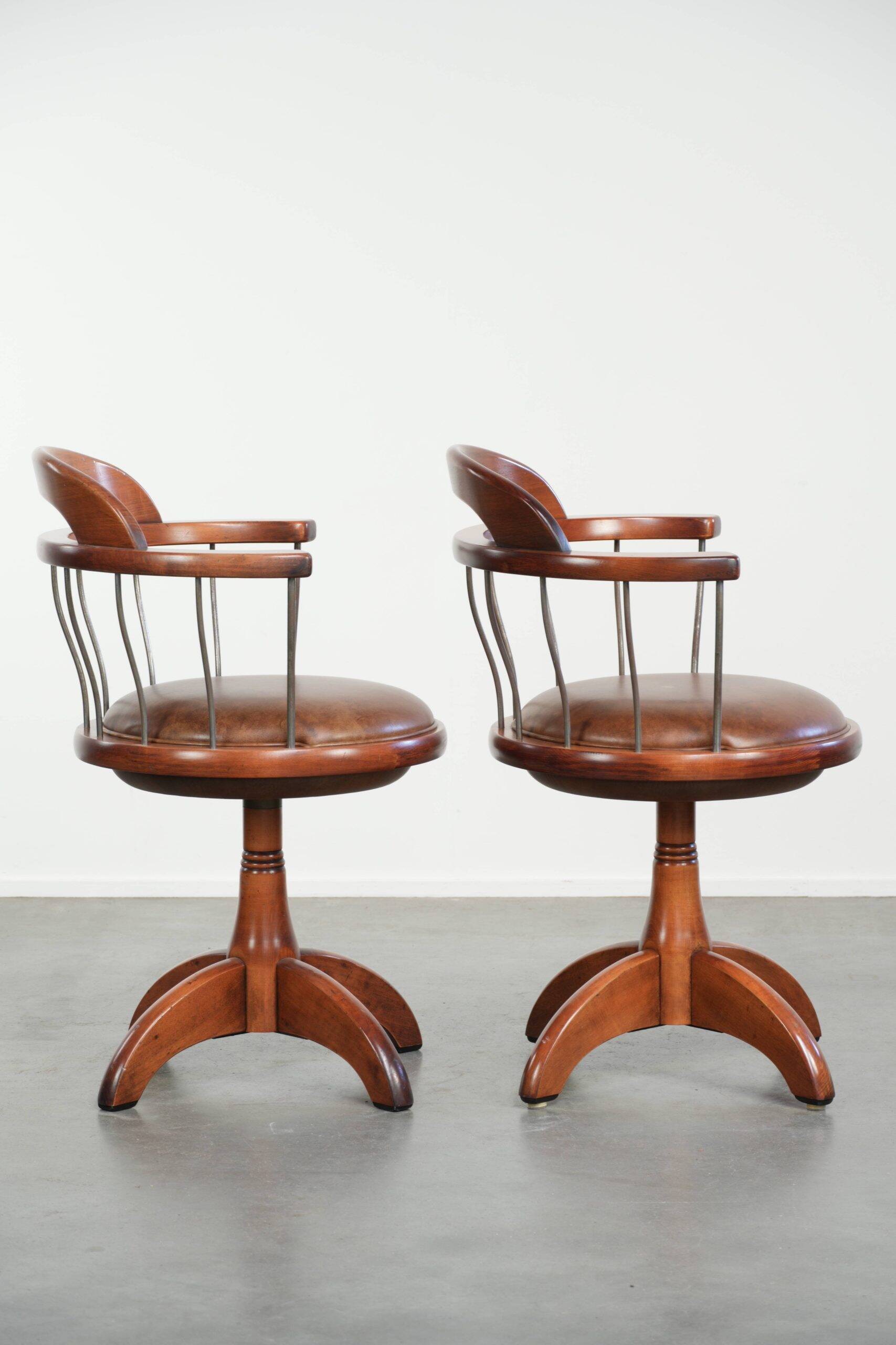 Set of 2 swivel/office chairs with a cognac-coloured cow leather seat