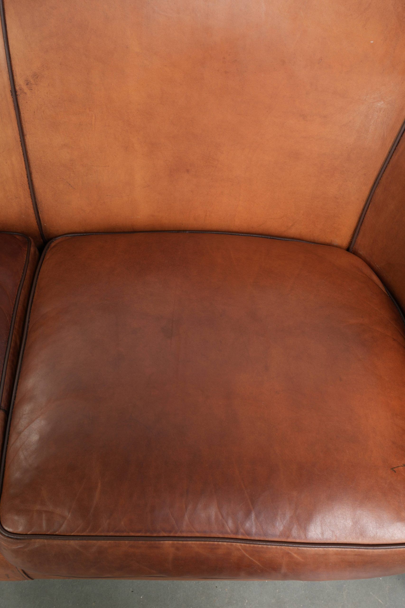 Sheepskin 2-seater sofa with a warm cognac brown colour scheme