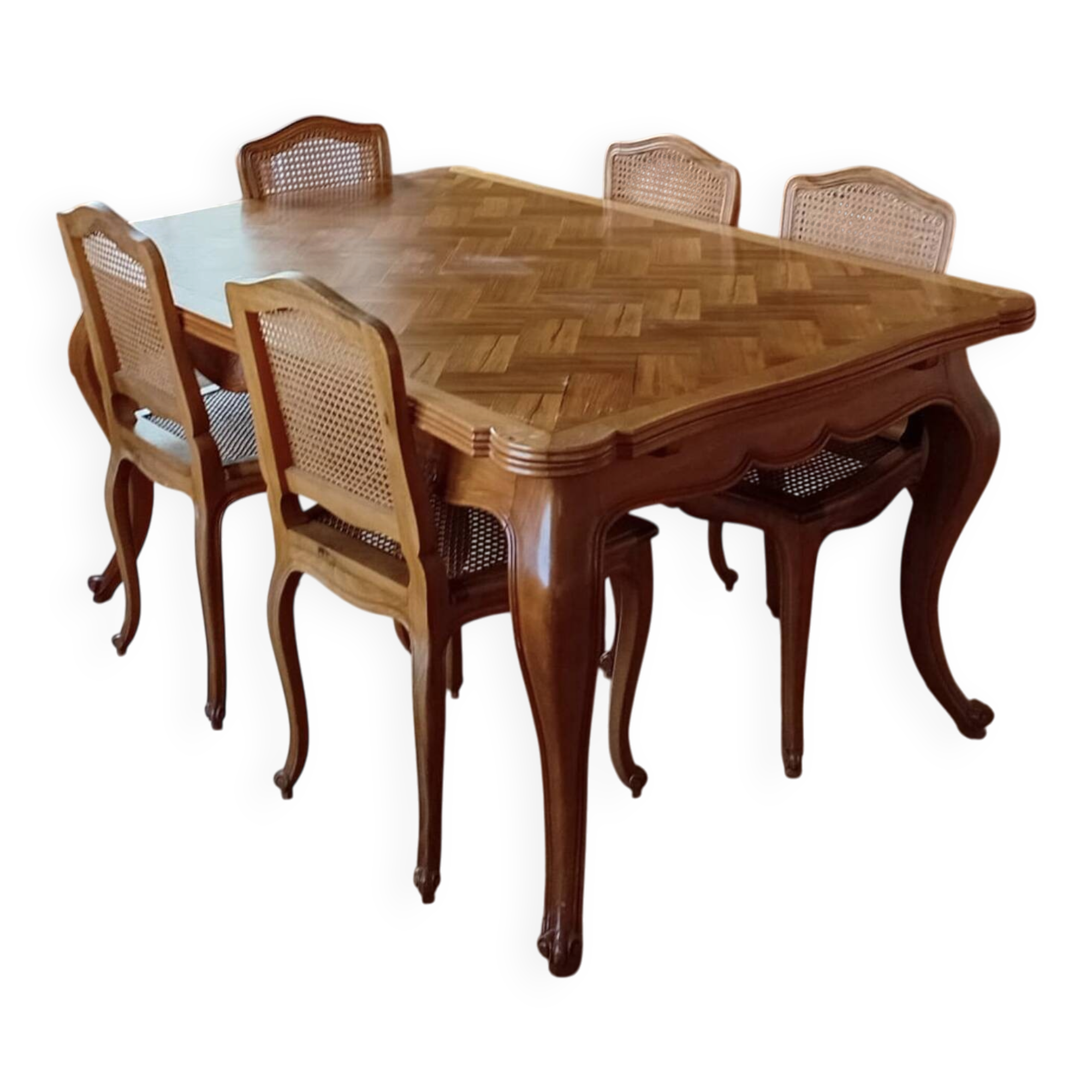 Carved wooden dining table and its 5 rattan caned chairs.