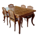 Carved wooden dining table and its 5 rattan caned chairs.