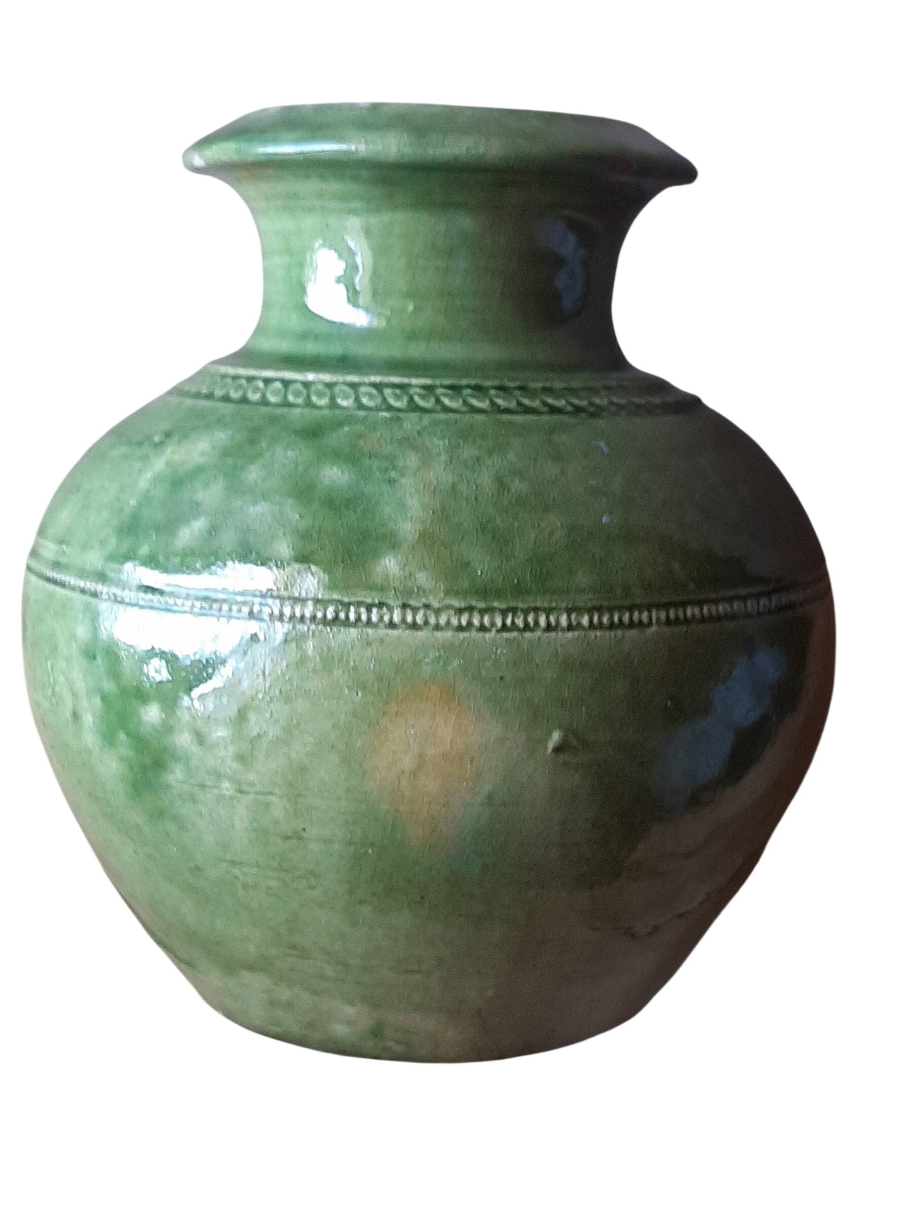 Ancient vase in glazed terracotta with green glaze.