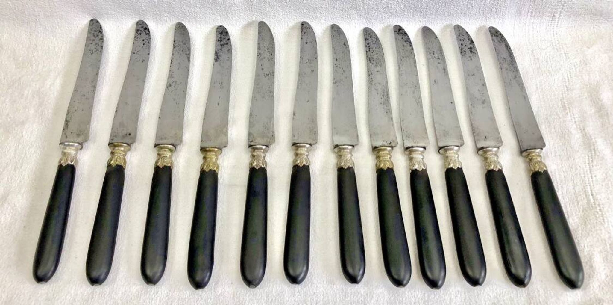 12 antique large table knives with ebony handles from the Napoleonic III period.