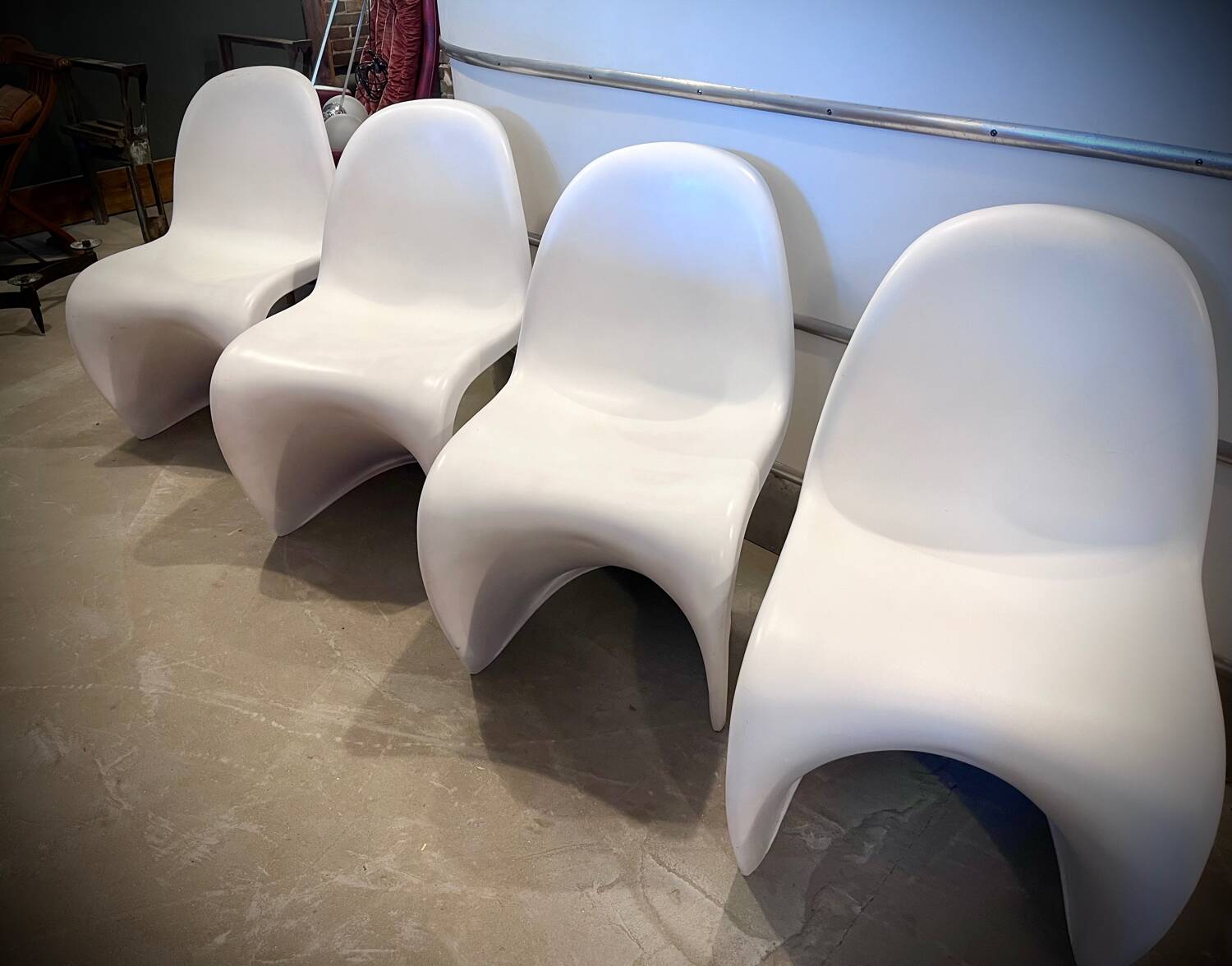 4 white Panton style armchairs