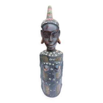 African statue of a woman, made of wood, brass, beads, and seashells.