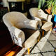 Pair of beige bouclette fabric frog chairs and their footrest.