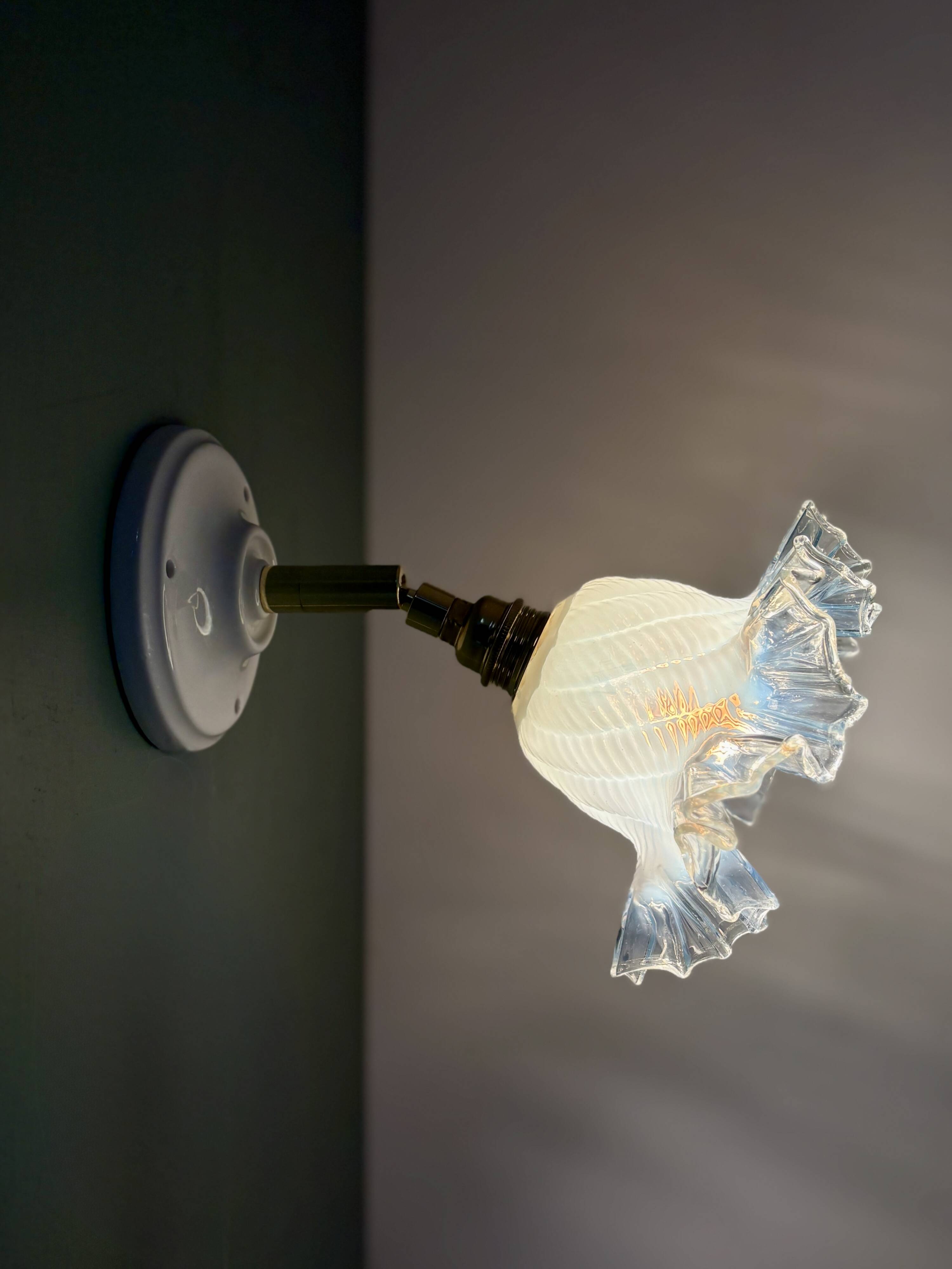 Vintage tulip glass wall light in transparent, slightly pearlescent white.