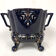 Large earthenware pot cover with enamelled decoration on a blue oven background