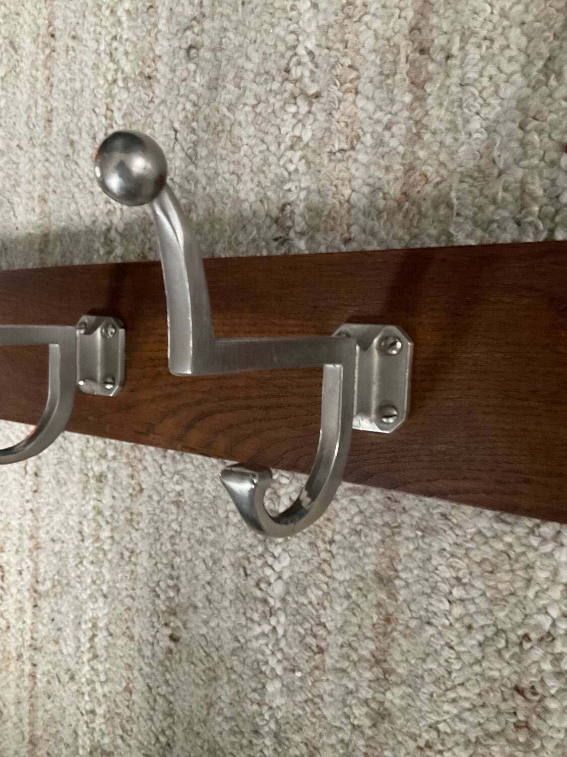 Wall coat rack from the 1950s-60s in solid oak and stainless steel.