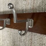 Wall coat rack from the 1950s-60s in solid oak and stainless steel.