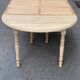 Round dining table with extendable leaves, Louis Philippe style, stripped in raw oak.