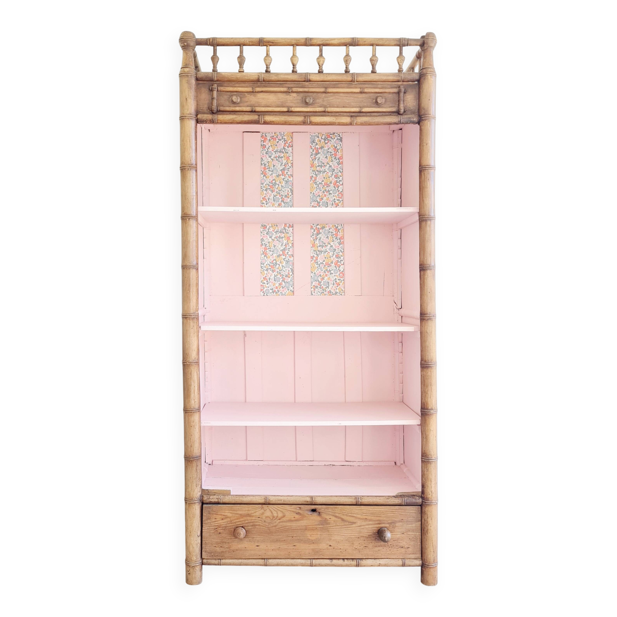 Library, old wooden cabinet imitating bamboo painted in pink