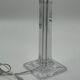 Modern table lamp in plexiglass with fabric shade.
