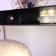 Brass hairdresser, glass and black plastic with its fluffy stool.