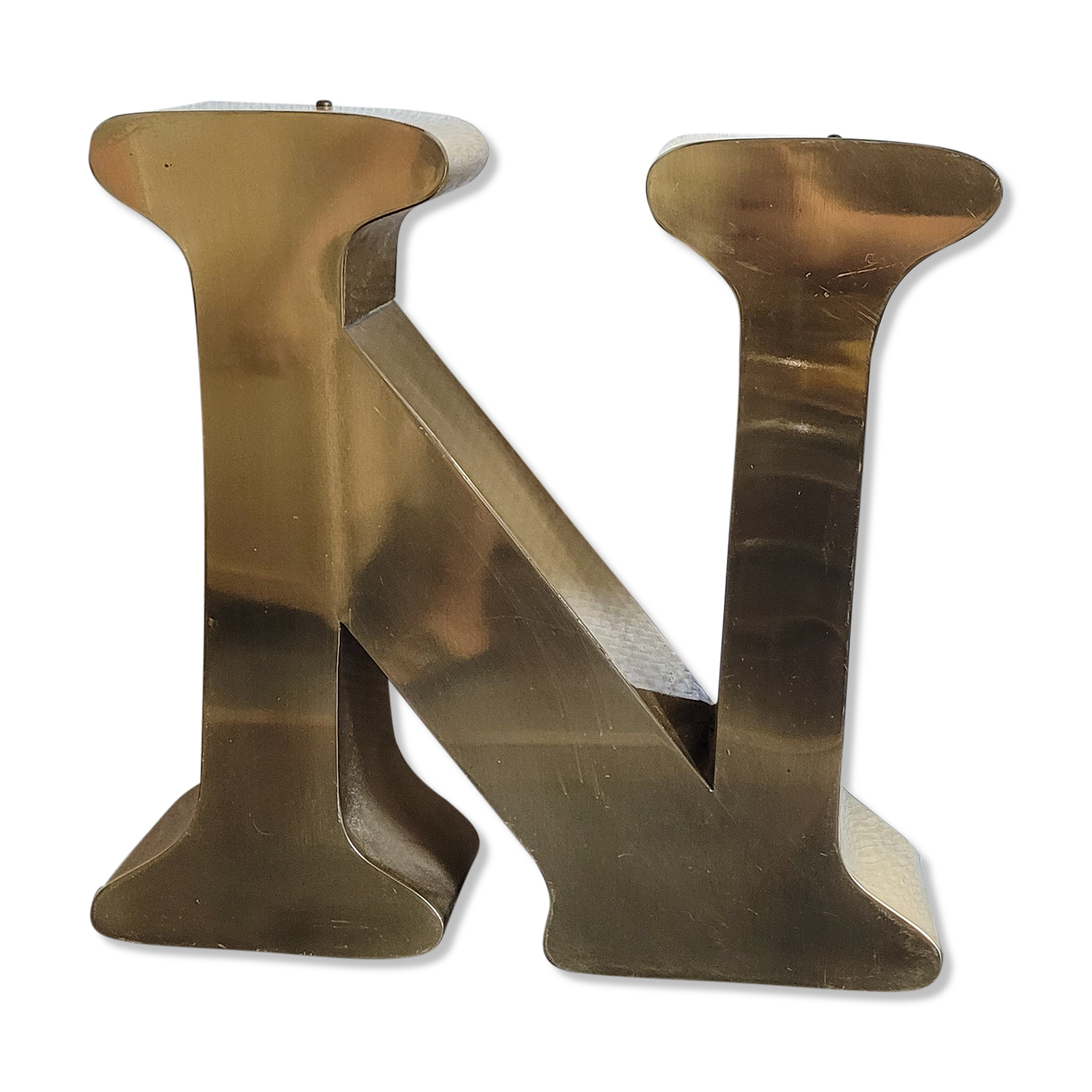 Old letter N of gilded metal sign