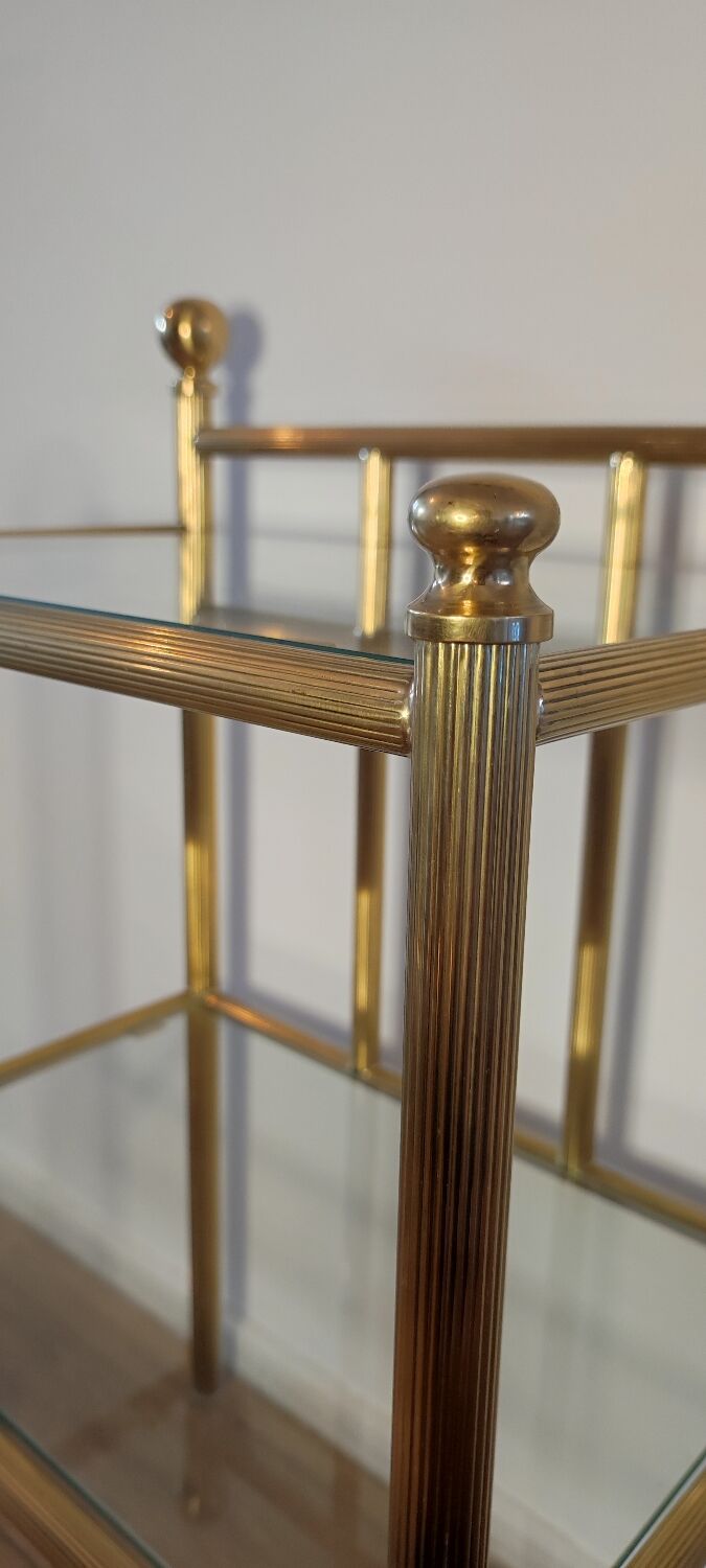 Bedside table in brass and glass.