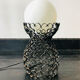 Handcrafted wrought iron lamp with a white opaline globe.