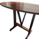 Oval folding table – mahogany veneer – V-shaped base – France, circa 1970