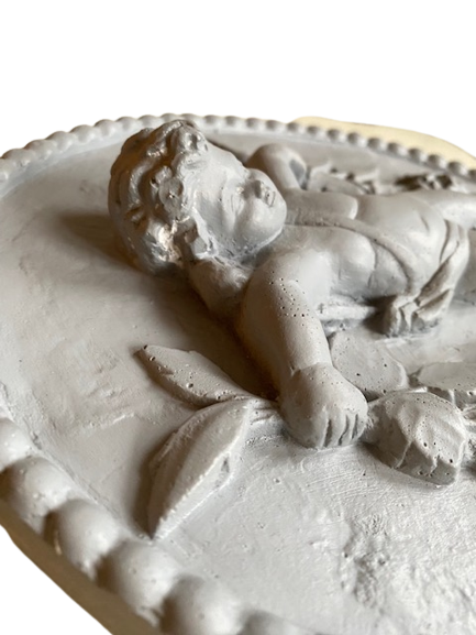 Plaster medallion cherub and garland of flowers patinated gray