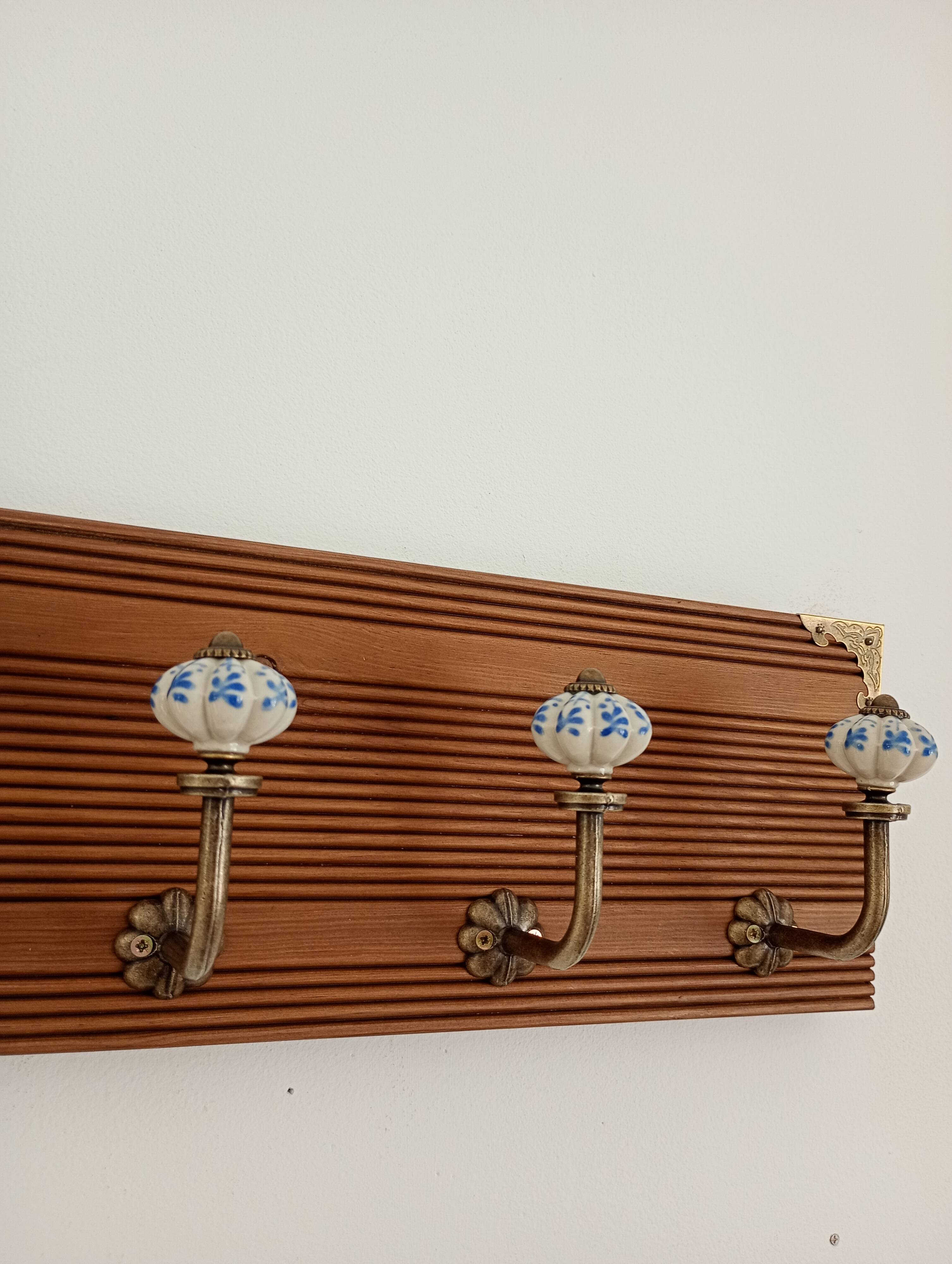 Wall-mounted coat rack with 4 ceramic hooks in blue and white, vintage style.