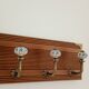 Wall-mounted coat rack with 4 ceramic hooks in blue and white, vintage style.